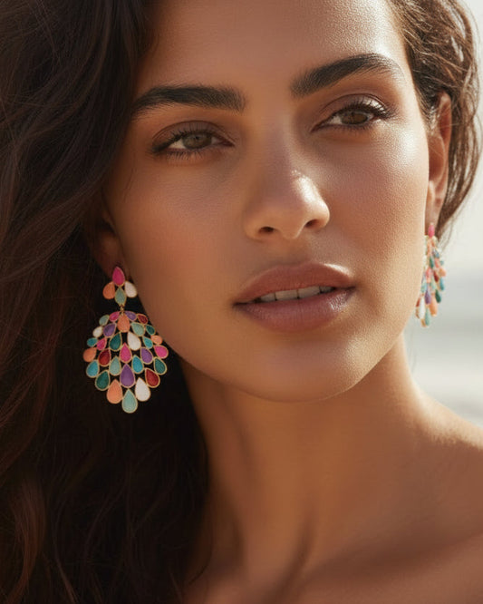 Woman wearing colorful earrings with a blurred beach background