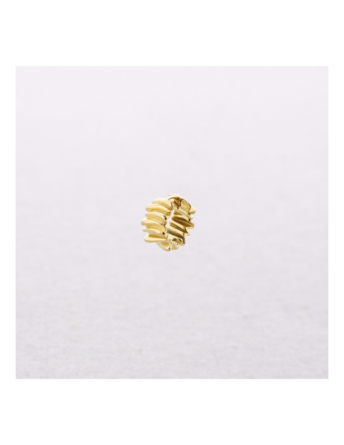 Gold ring with multiple bands on a white background