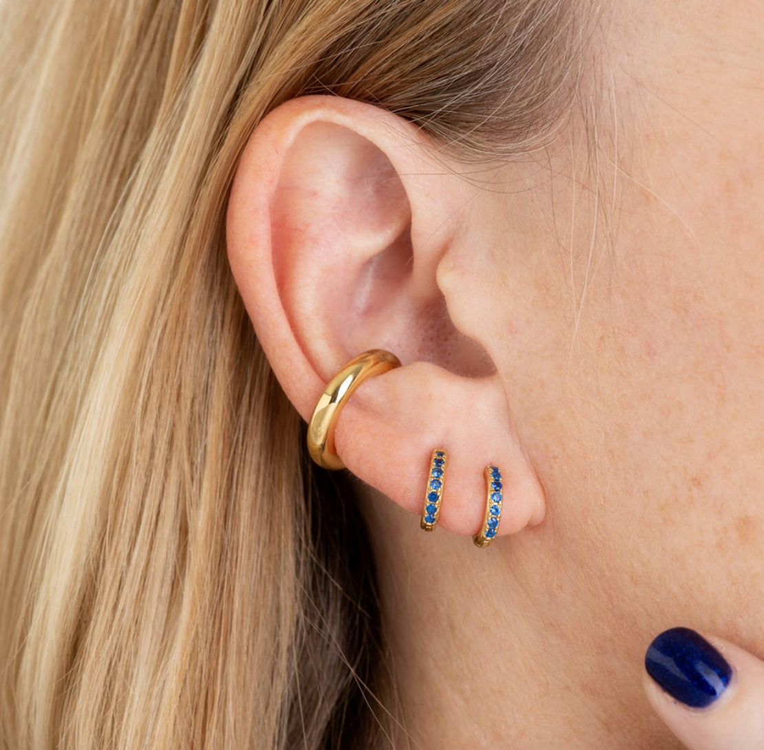 Gold huggies with blue stones