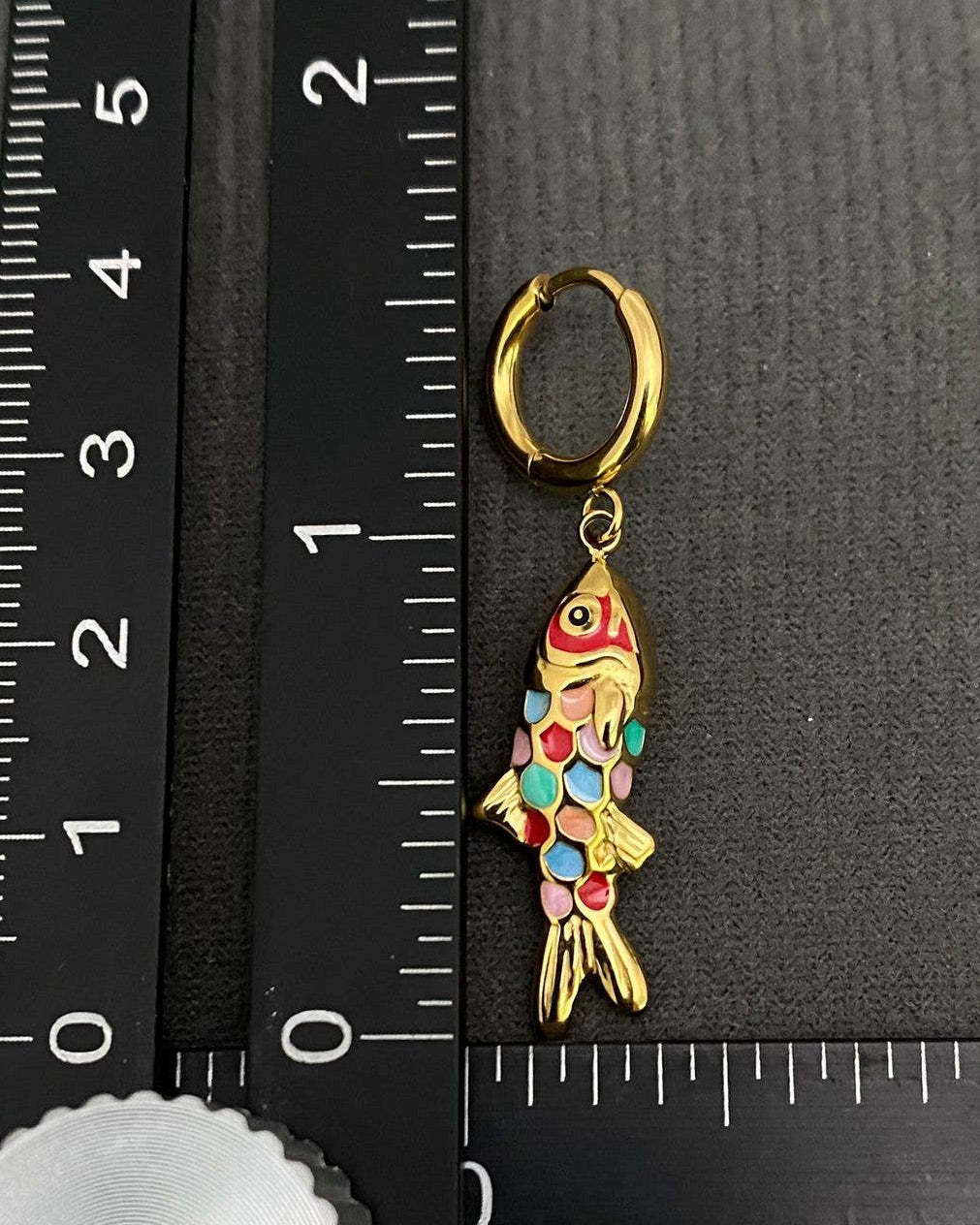 Vibrant enamel fish huggie earrings - showing size