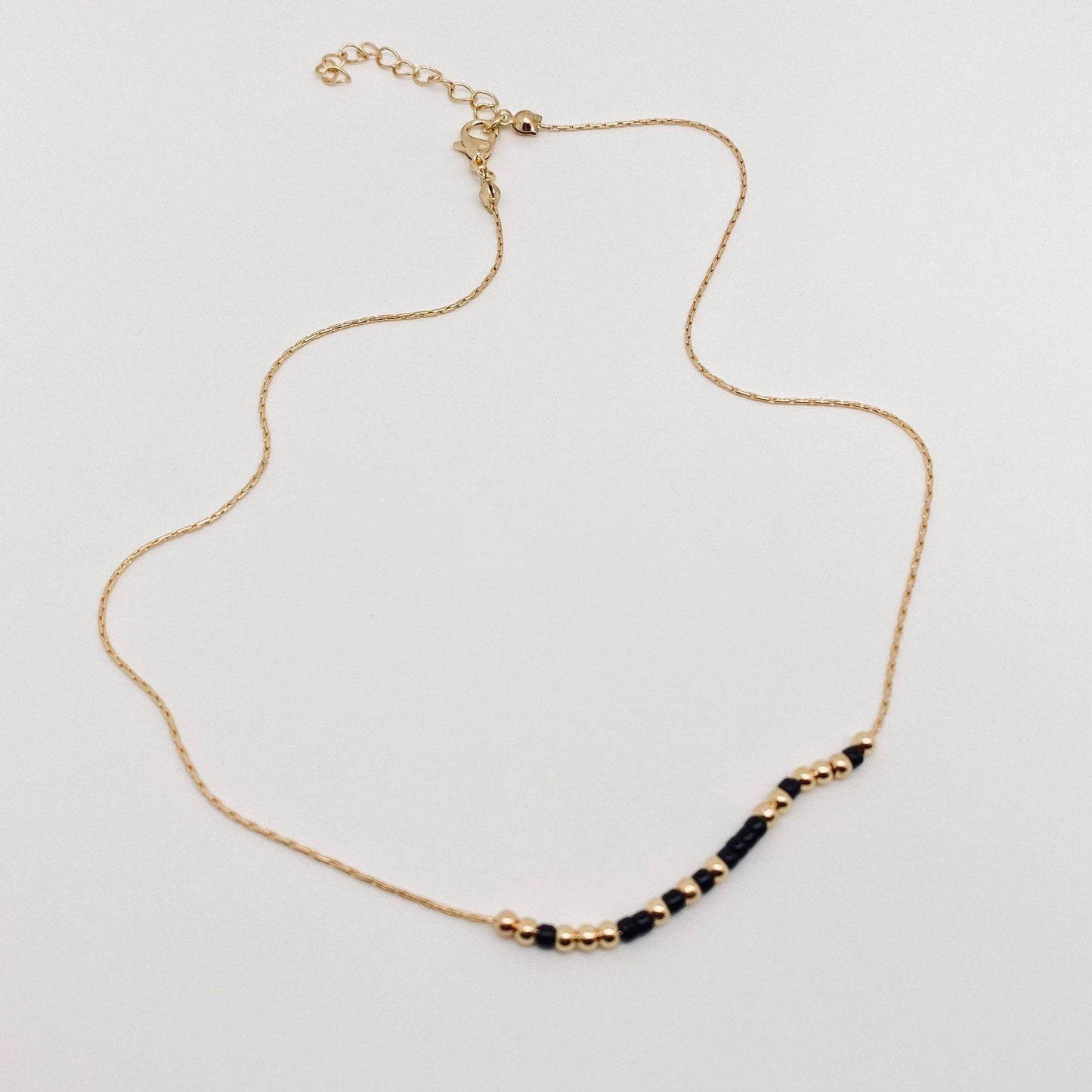 Delicate gold morse code necklace with secret empowerment message