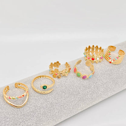 Set of gold and multicolored rings on a textured surface