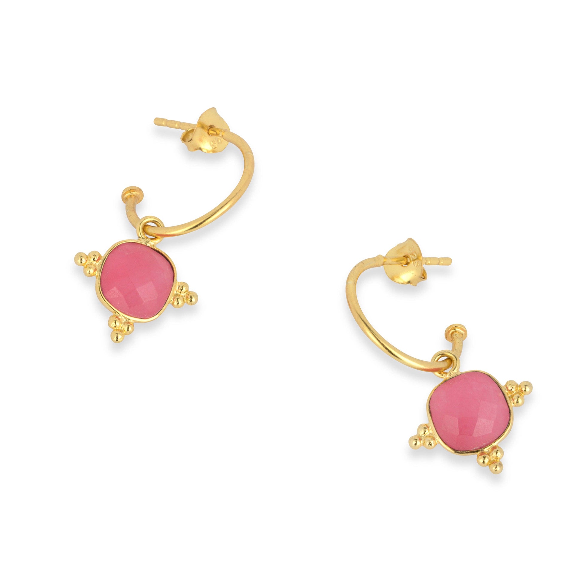 Gold hoop earrings with pink stones on a white background