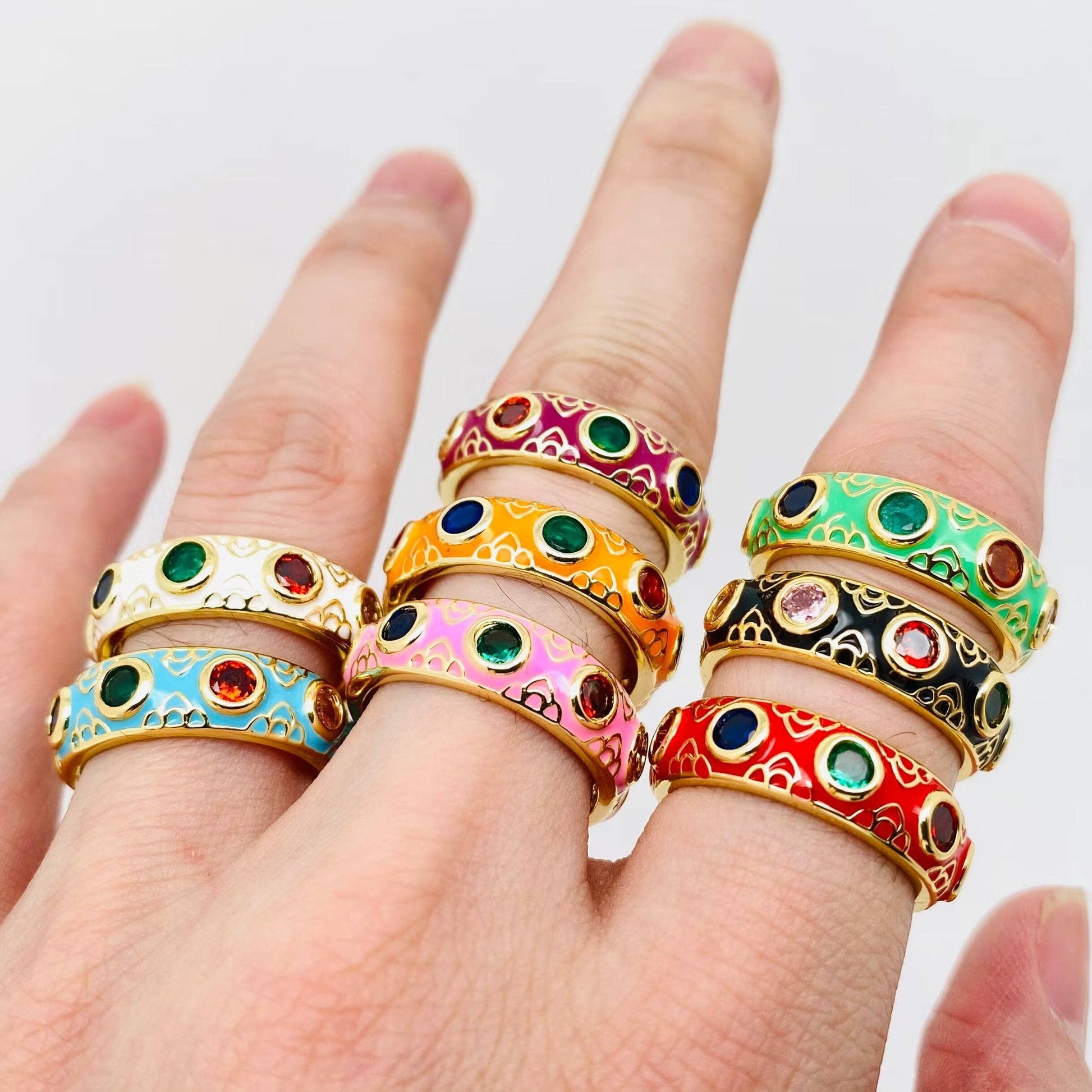 Close-up of rainbow cubic zirconia stones on  enamel rings of all colourways