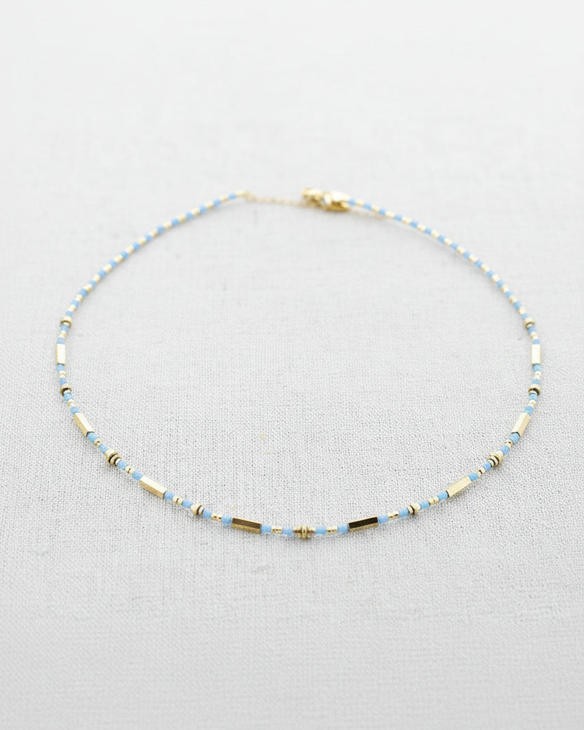 Beaded necklace on a light gray background