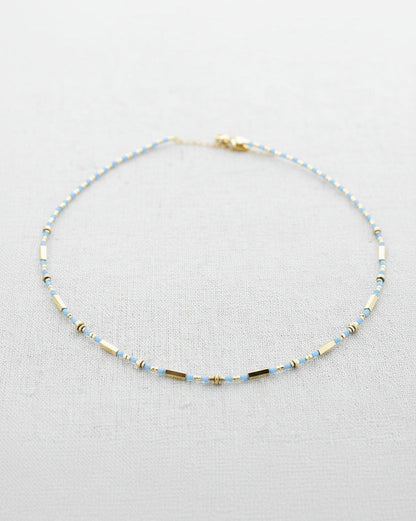 Beaded necklace on a light gray background