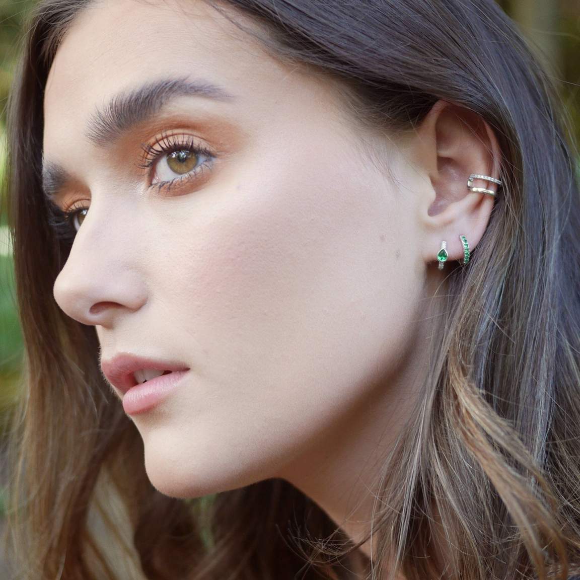 Gold huggies with green stones