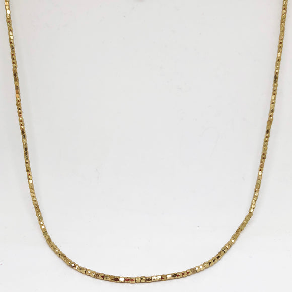 Long cut gold metal bead necklace